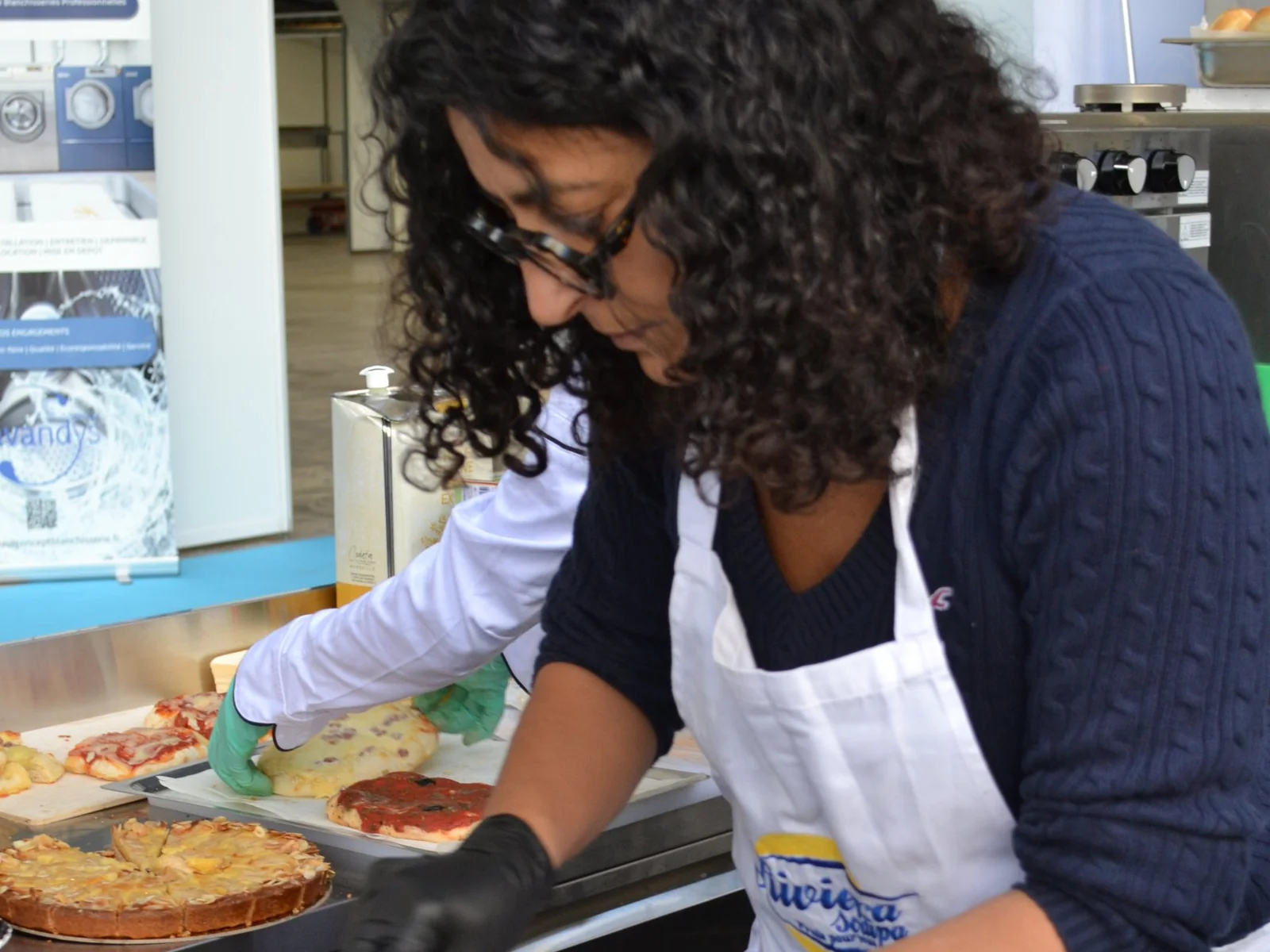 Riviera Sodipa team member preparing octopus bites at Agecotel